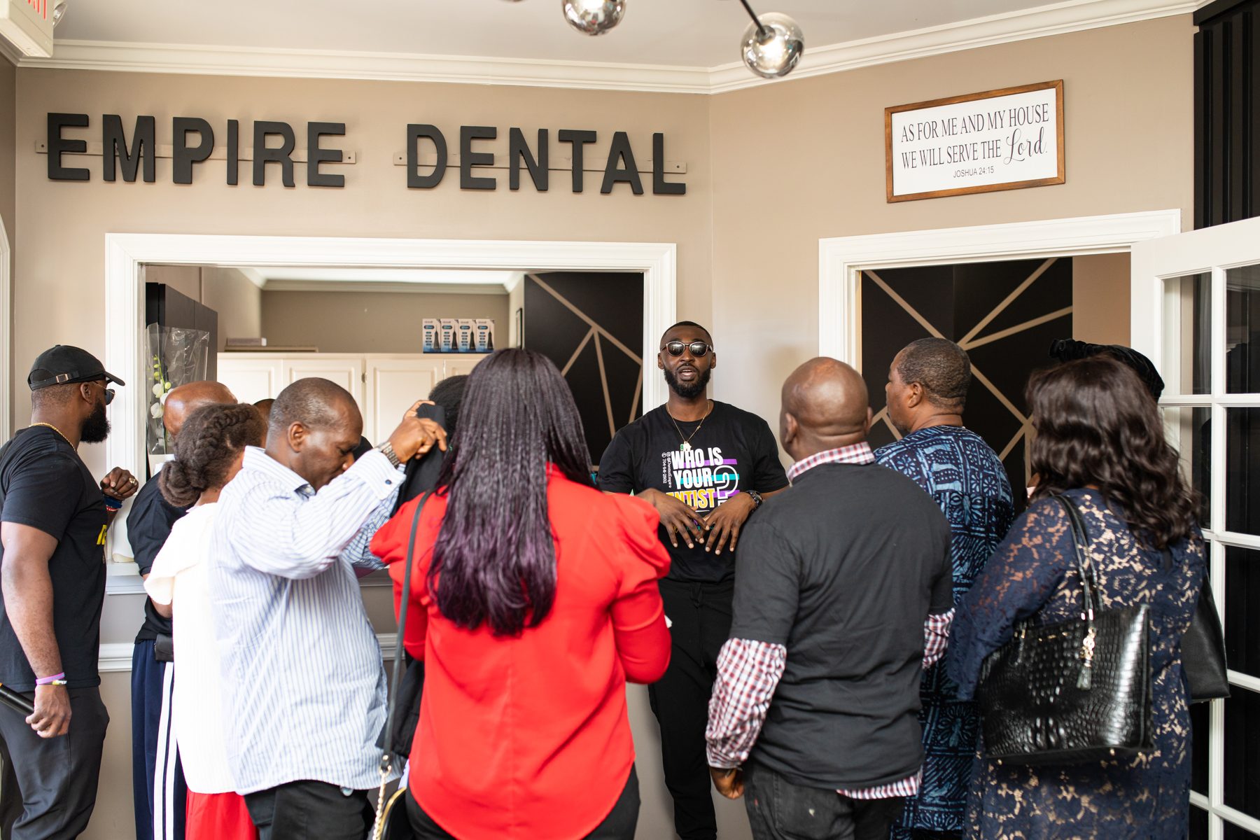 Dentists and community gathered inside a newly opened dental practice