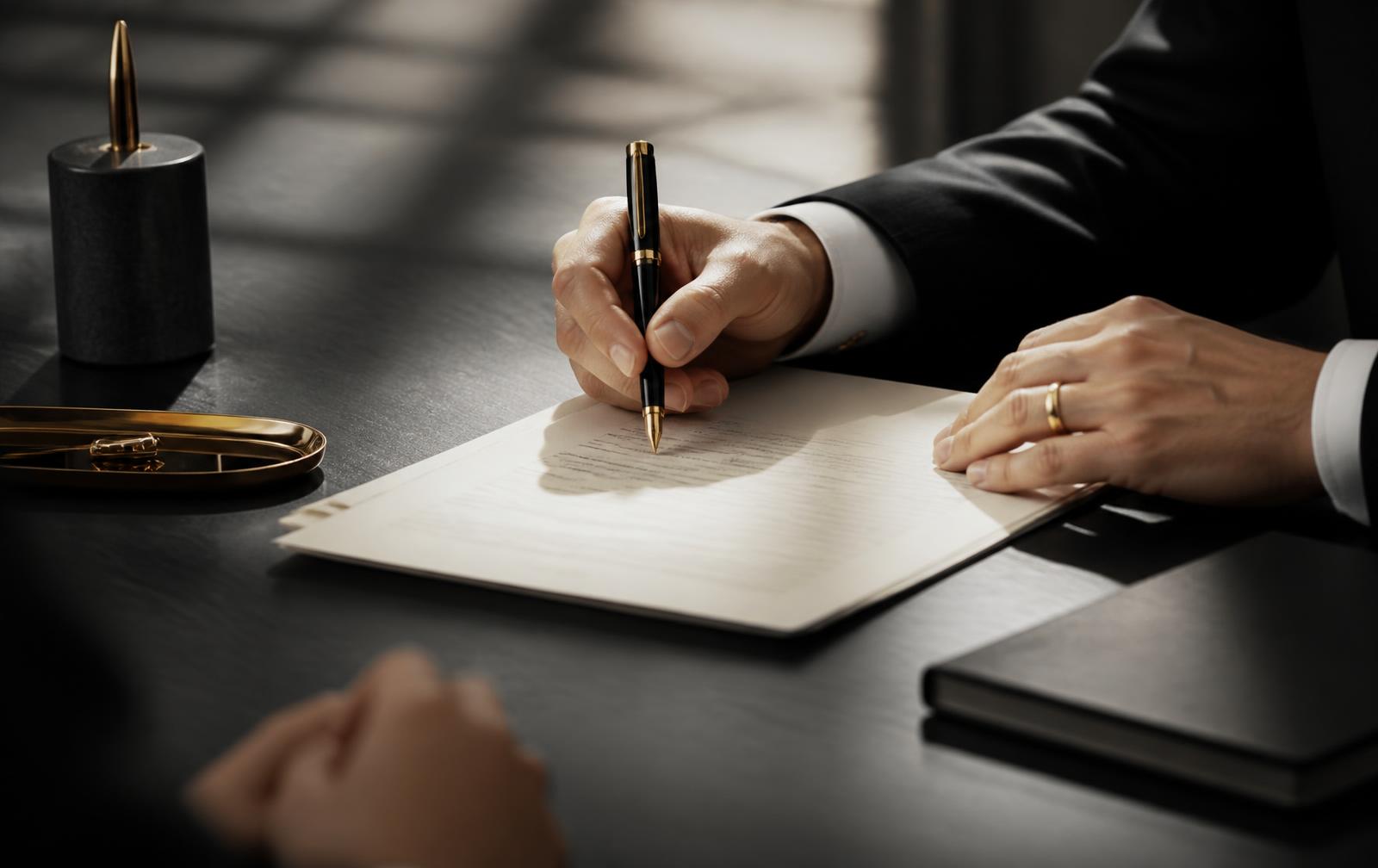 Purchase agreement being signed at a desk